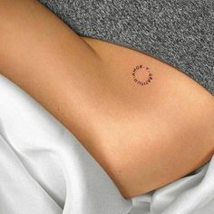 a woman with a small tattoo on her stomach