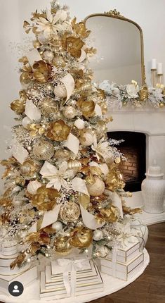 a christmas tree with gold and white decorations