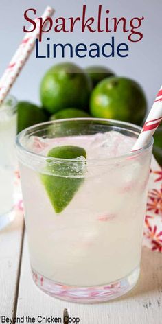 two glasses filled with limeade sitting on top of a table