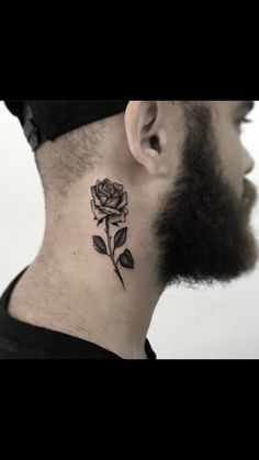 a man with a black rose tattoo on his neck