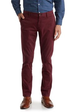 A solid hue makes these chino pants a versatile, everyday classic staple for your closet. 9" rise, 32" inseam (size 32x32) Trim fit Zip fly with button closure 2 front slash pockets; 2 back button welt pockets 97% cotton, 3% spandex Machine wash, tumble dry Imported Model stats: 6'1" height, 32" waist. Model is wearing size 32x32. Slim Fit Cotton Chinos For Business Casual In Fall, Slim Fit Chinos For Business Casual In Fall, Fall Slim Fit Chinos For Business Casual, Fall Business Casual Chino Cotton Twill Bottoms, Fitted Chino Cotton Twill Pants For Fall, Fitted Chinos For Fall With Straight Hem, Slim Fit Straight Leg Solid Chinos, Slim Fit Chinos With Welt Pockets For Fall, Classic Slim Fit Chinos For Fall