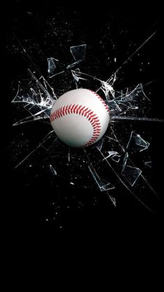 a baseball that is in the middle of a broken glass window with it's reflection