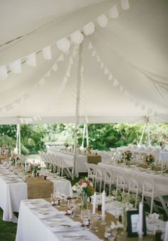 tables and chairs are set up under a tent