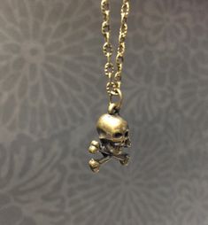 Simple, brass plated skull necklace. Choose your chain length or black cotton cord and I will make one just for you. Product details 3D human mini skull charm is bronze plated Choose your chain length with matching clasp or black cotton cord. Thank you for supporting small business VISIT MY SHOPS HERE * http://www.etsy.com/shop/HappyCatHouse * http://www.Etsy.com/shop/AnEnchantingCreature CONNECT * http://www.facebook.com/EnchantingCreature * https://instagram.com/EnchantingCreature * https://ww Metal Skull Necklace With Skull Print, Metal Skull Print Necklace For Gift, Skull Print Metal Necklace For Gift, Bronze Skull Jewelry For Gifts, Bronze Skull Jewelry Gift, Bronze Skull-shaped Jewelry Gift, Skull Necklace, Creating Jewelry, Skull And Crossbones