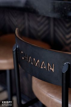 there are two chairs that have the name graham on them and one is black with gold lettering