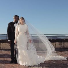 a bride and groom posing for a photo