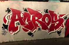 graffiti on the side of a building with red and black letters that say arrol