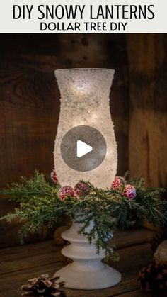 a white vase with flowers and pine cones on it is shown in the video titled diy snow lanterners dollar tree diy