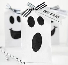 two white bags with black polka dots and a ghost face tied to the top one