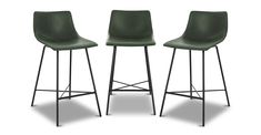 two green chairs sitting next to each other on top of a white surface with black legs