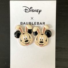 pair of mickey mouse ear clips with swarong ears on display in front of disney x baublebar sign