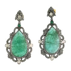 Charming Hand Carved Drop shape Emerald Dangle Earring in 18K Gold and Silver with diamond designer motif around. Closure: Push Post 18kt Gold:1.65gms Diamond:3.19cts Silver:10.99gms Emerald:60.95cts Emerald Diamond Earrings, Yellow Gold Diamond Earrings, Diamond Dangle Earrings, Gold Diamond Earrings, Rare Gems, Emerald Earrings, Yellow Gold Earring, Modern Earrings, Gold Earrings Dangle