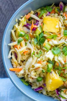 a blue bowl filled with coleslaw and pineapple