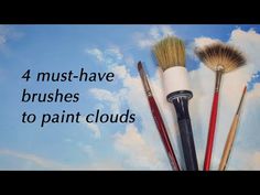 four brushes are placed next to each other in front of a blue sky with clouds