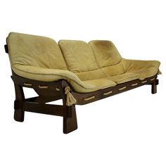 a wooden and leather chaise lounge with tassels