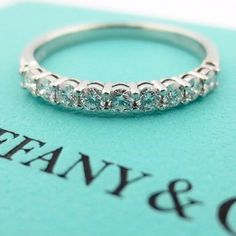 a close up of a ring on top of a book with the words tiffany & co written below it