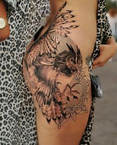 a woman's stomach with an owl and flower tattoo design on it, in front of a leopard print shirt