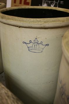 three white pots with blue designs on them