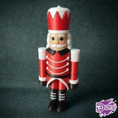 a toy nutcracker wearing a red uniform