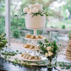 a three tiered cake and pastries on a table