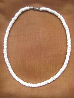 "Natural Puka Shell Choker Necklace Length: 18\" or 20\" Long You are purchasing 2 PUKA SHELL necklace. Necklace Color: White This is a beautiful and genuine puka shell necklace. Hand-crafted with natural shells, this necklace will bring delight to wear in any occasion. The shape and design makes it easy to match any attire that you own. Make it a complete set when you purchase different necklace designs or a bracelet to go along with it. Please note that because the shells are natural, size and Adjustable White Shell Necklace Gift, Adjustable White Shell Necklace For Gift, White Shell Necklace With Lobster Clasp As Gift, Adjustable 16 Inch White Jewelry, White Beach Necklace, Surfer Jewelry, Puka Shell Necklace, Shell Choker, Surfer Necklace