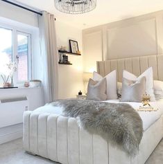 a bedroom with a large bed and white walls