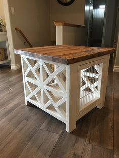 a kitchen island made out of wood with a cage on top and a clock above it