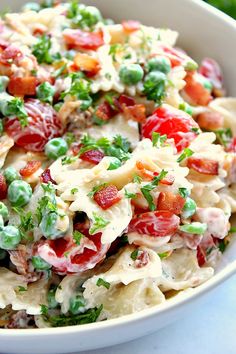 a white bowl filled with pasta salad on top of a table