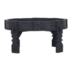 a black wooden bench with carvings on the top and bottom, sitting in front of a white background