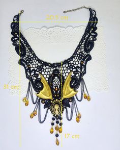 Victorian Gothic black lace collar necklace with bat skull cameo, yellow faceted crystal drops and golden bat wings, macabre cameo, Halloween jewelry Beautiful and soft macramé black lace decorated with pearl and crystal rhinestones. The bat skull cameo measures approx. 1.8x2.5 cm and is made in resin with shades and shadows brush-painted with acrylic colors. The metal frame measures approximately 3.3x3.5 cm and stands out beneath a pair of golden tone brass bat wings. Some black metal chains an Gold Fantasy Jewelry For Halloween, Steampunk Black Necklace For Halloween, Steampunk Gold Jewelry For Halloween, Gothic Gold Jewelry For Halloween, Skull Cameo, Bat Skull, Jewelry Beautiful, Victorian Gothic, Halloween Jewelry