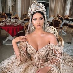 a woman in a wedding dress posing for the camera