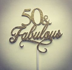 a 50th birthday cake topper with the number 50 and fabulous written in gold glitter