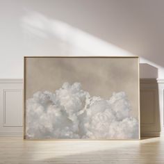 an empty room with a large painting on the wall and wooden flooring in front of it