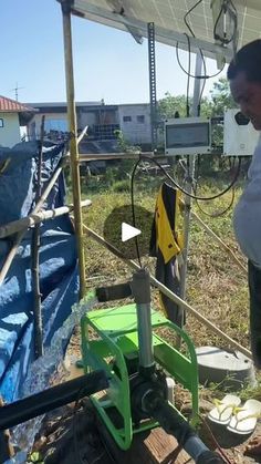 a man standing in front of a solar panel with an electric device on top of it