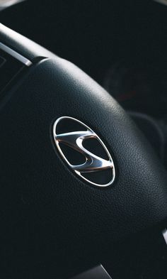 the interior of a car with steering wheel and dash board buttons on it's center console