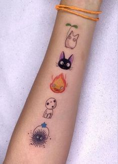 a woman's arm with tattoos on it and various animals drawn on the wrist