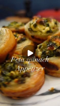 there are many small pastries on the plate with words that read feta spinach appetizer