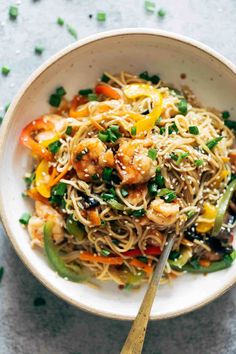 a white bowl filled with noodles and vegetables