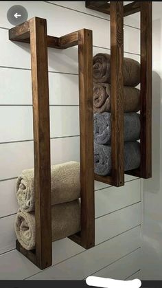 two wooden shelves holding towels and folded towels