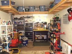 a garage filled with lots of tools and other things on the shelves, including an overhead workbench