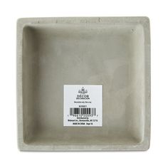 a gray square bowl with a barcode sticker on it