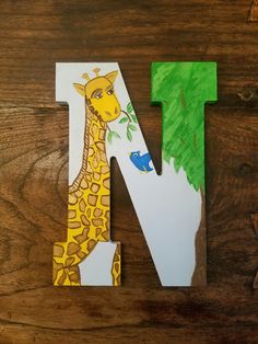 the letter n is for giraffe with leaves on its neck and head, next to a drawing of a fish