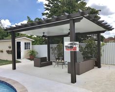 a backyard with a pool and pergolated area next to the fenced in yard