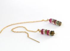 Elegant with just the right amount of color to stand out.  Simple, elegant and easy to wear tourmaline ear threads in gold filled.  Tourmaline offers a stunning array of jewel tones and each pair of theaders is completely unique.  The gold filled option features yellow, raspberry pink, blue green, brown and pine green in one striking ear threader.    Colorful and sophisticated, the ear threaders are 3 inches in length.  Also available in sterling silver. *Colorful tourmaline in jewel tones *Gold 40th Birthday Gifts For Women, Ear Threader, October Birthstone Jewelry, Threader Earrings Gold, Tourmaline Earrings, Raspberry Pink, Pretty Packaging, 40th Birthday Gifts, Earrings Ear