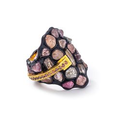 This unusual ring by German Kabirski is a celebration of raw, natural beauty. Featuring rough mixed spinel stones, wrapped in silver and arranged like a precious puzzle, these gems remain unspoiled, just as they were found. A line of round-cut orange sapphires adds a vibrant contrast along the side of the wide band. Crafted from 925 silver and plated with deep-black Anthracite and 18K gold, this piece highlights the individual flaws and natural charm that make each stone, and each person, beauti German Kabirski, Piece Highlights, Cut Orange, Jewelry Magazine, September Birthstone Jewelry, Unusual Rings, Stocking Fillers For Her, Fine Art Jewelry, Gold Gifts