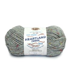 a gray ball of yarn with multicolored sprinkles on the side