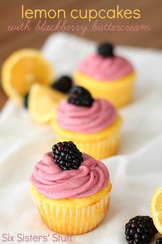 lemon cupcakes with blackberry buttercream and blackberries are on a napkin