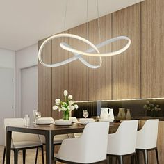 a dining room table with white chairs and a light fixture hanging from it's ceiling