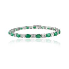 This is part of Chairish’s Fine Jewelry assortment.  This Natural Emerald and Diamond Tennis Bracelet in 18K gold showcases 17 endlessly sparkling natural emerald, weighing 6.64 carat and 170 pieces of diamonds weighing 1.57 carat. It measures 7 inches long in length.  Emerald enhances intellectual capacity of the person. Designed with perfect oval cut emerald with cluster diamonds in after each emerald to make you stand out on any occasion or event. The elegant style complements the attire beau Luxury Silver Tennis Bracelet With Emeralds, Formal Emerald Diamond Bracelet With Brilliant Cut, Luxury Green Brilliant Cut Diamond Bracelet, Formal Emerald Diamond Bracelet, Formal Emerald Cut Diamond Bracelet, Luxury Green Tennis Bracelet For Formal Events, Emerald Diamond Bracelet In White Gold For Formal Events, Luxury Emerald Cut Green Diamond Bracelet, Formal White Gold Diamond Bracelet With Emerald