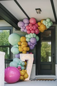 balloons and letters are on the front porch